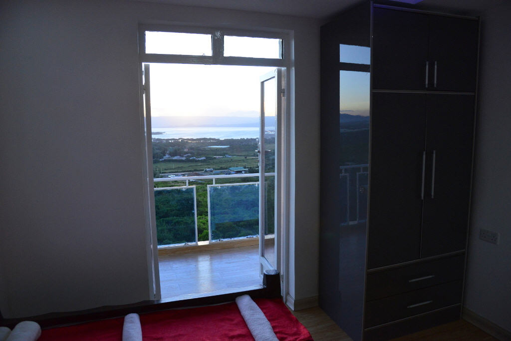 Bedroom with a balcony overlooking Lake Naivasha